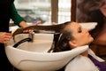 Hairdresser making hair treatment to a customer in salon Royalty Free Stock Photo