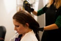 Hairdresser making hair treatment to a customer in salon Royalty Free Stock Photo