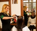 Hairdresser making hair treatment to a customer in salon Royalty Free Stock Photo