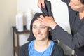 Hairdresser patting dry a young womans hair