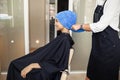 Hairdresser puts towel on woman`s hair, hairsalon