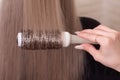 Hairdresser\'s hand brushing hair