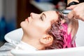 Hairdresser`s hands washing dyed hair