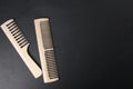 Hairdresser\'s tools. Two wooden combs lie on a black background with space for copyspace text. Natural Comb Royalty Free Stock Photo