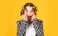 Hairdresser salon. Girl with curlers and hair clips in her hair on yellow background. Little girl curlers around her