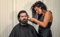 Hairdresser shaving client hipster head in barbershop, hair care