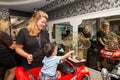 Hairdresser shearing a child