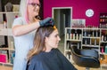 Hairdresser showing hair dye sample to young woman Royalty Free Stock Photo