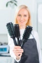 Hairdresser showing several hairbrushes Royalty Free Stock Photo