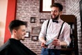 Hairdresser shows customer a quality hair gel Royalty Free Stock Photo