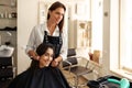 Hairdresser and smiling woman, hairdressing salon Royalty Free Stock Photo