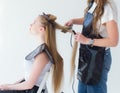 Hairdresser smooths the hair of a client with a curling iron Royalty Free Stock Photo