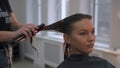 Professional hair straightening young beautiful model in beauty salon