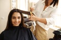 Hairdresser straightens woman`s hair, hairsalon