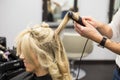 Hairdresser styling woman's hair