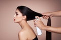 Hairdresser styling woman`s hair