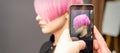 Hairdresser takes pictures of hairstyle Royalty Free Stock Photo