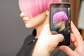 Hairdresser takes pictures of hairstyle Royalty Free Stock Photo