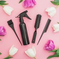 Hairdresser tool - spray, combs and tulips flowers on pink background. Beauty concept. Flat lay, top view Royalty Free Stock Photo