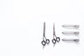 Hairdresser tools in beauty salon. Sciccors and barrette on white background top view copyspace