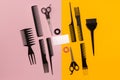 Hairdresser tools on pink and yellow background with copy space, top view, flat lay. Royalty Free Stock Photo