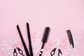 Hairdresser tools - spray, combs and tulips flowers on pink background. Beauty concept. Flat lay, top view Royalty Free Stock Photo