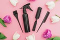 Hairdresser tools - spray, combs and tulips flowers on pink background. Beauty concept. Flat lay, top view Royalty Free Stock Photo