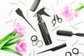 Hairdresser tools - spray, scissors, combs, barrette and tulips flowers on white background. Beauty concept. Flat lay, top view Royalty Free Stock Photo