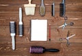 Hairdresser tools on wooden background. Blank card with barber tools flat lay. Top view on wooden table with scissors, hairbrushes