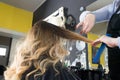 Hairdresser trimming ombre hair with scissors Royalty Free Stock Photo