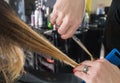 Hairdresser trimming ombre hair with scissors