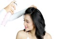 Hairdresser using a hairspray for her model