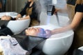 Hairdresser is using Nano Mist Hair Treatment Streamer Machine, Modern equipment for Young Happy Asian Beautiful Caucasian Woman