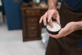 Hairdresser using pomade to hair styling.