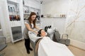 Hairdresser washes her hair with shampoo and massages the head of a young woman in a barber salon Royalty Free Stock Photo