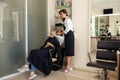 Hairdresser washes woman`s hair, hairsalon Royalty Free Stock Photo