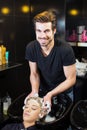 Hairdresser washing girls hair