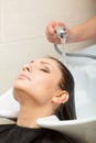 Hairdresser washing her woman customer hair Royalty Free Stock Photo