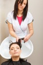 Hairdresser washing her woman customer hair Royalty Free Stock Photo