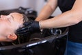 Hairdresser washing woman hair in salon. Selective focus. Royalty Free Stock Photo