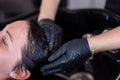 Hairdresser washing woman hair in salon. Selective focus. Royalty Free Stock Photo