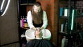 Hairdresser washing woman's hair