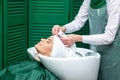 Hairdresser wrapping woman`s hair in towel Royalty Free Stock Photo