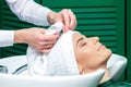 Hairdresser wrapping woman`s hair in towel Royalty Free Stock Photo