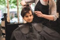 Hairdressers hands making hairstyle to child little boy in the barber shop hair cut professional - Little boy in the barber shop Royalty Free Stock Photo