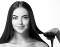 Hairdressing process. Girl model Hair Straightening Irons.Beautiful Woman with Long Straight Hair. Healthy Hair. Royalty Free Stock Photo