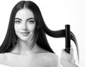 Hairdressing process. Girl model Hair Straightening Irons.Beautiful Woman with Long Straight Hair. Healthy Hair. Royalty Free Stock Photo