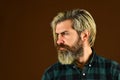 Hairdressing salon. Hipster bleached hair. Barber fashionable master. Bearded man long beard. Brutal caucasian hipster Royalty Free Stock Photo
