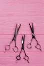 Hairdressing scissors on pink wooden background. Royalty Free Stock Photo