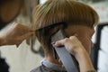 Hairdressing services. A man cuts hair at a hairdresser-stylist in a barbershop. scissors comb, clipper close-up.Barber at work. Royalty Free Stock Photo